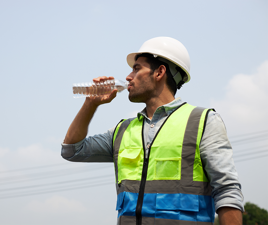 National Emphasis Program: A construction worker drinking a bottle of water.